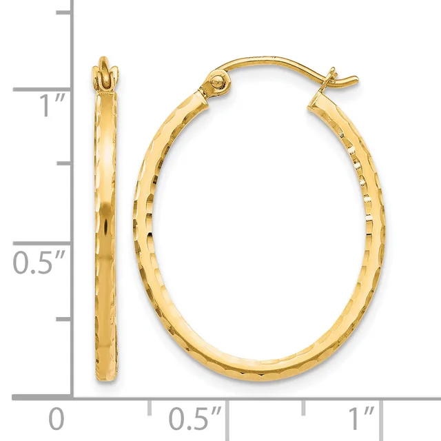 Gold oval hoop earrings with textured surface shown next to a measurement ruler indicating approximately one inch in length.