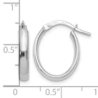 A pair of polished silver-colored oval hoop earrings with a hinged clasp, shown next to a measurement scale indicating approximately one inch in height and half an inch in width.