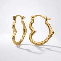 A pair of gold twisted hoop earrings with hinged closures, displayed against a white background with subtle shadows.