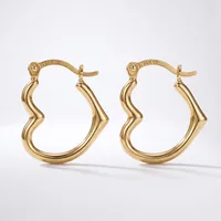 A pair of gold-toned hoop earrings with a wavy, curved design and hinged posts, displayed against a white background.
