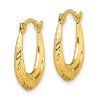 A pair of gold hoop earrings with textured surfaces and polished smooth sections, featuring curved clasps at the top.