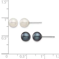 Two pairs of pearl stud earrings displayed on a ruler: white pearls on top and dark gray pearls below, each pair mounted on silver posts.