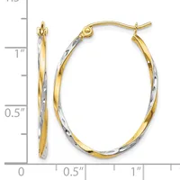 Two-tone gold oval hoop earrings with a textured white gold outer surface and smooth yellow gold inner surface, shown next to a measurement scale.