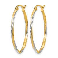 A pair of two-tone gold hoop earrings with twisted diamond-cut surfaces and post-and-clutch closures.