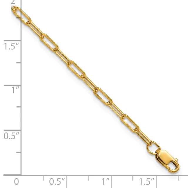 Gold paperclip chain bracelet displayed next to a ruler showing approximately 1.5 inches in length, with a lobster clasp at one end.