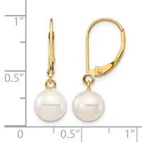 Pair of gold leverback earrings with white pearl drops, displayed next to a measurement scale showing approximately one inch in length.