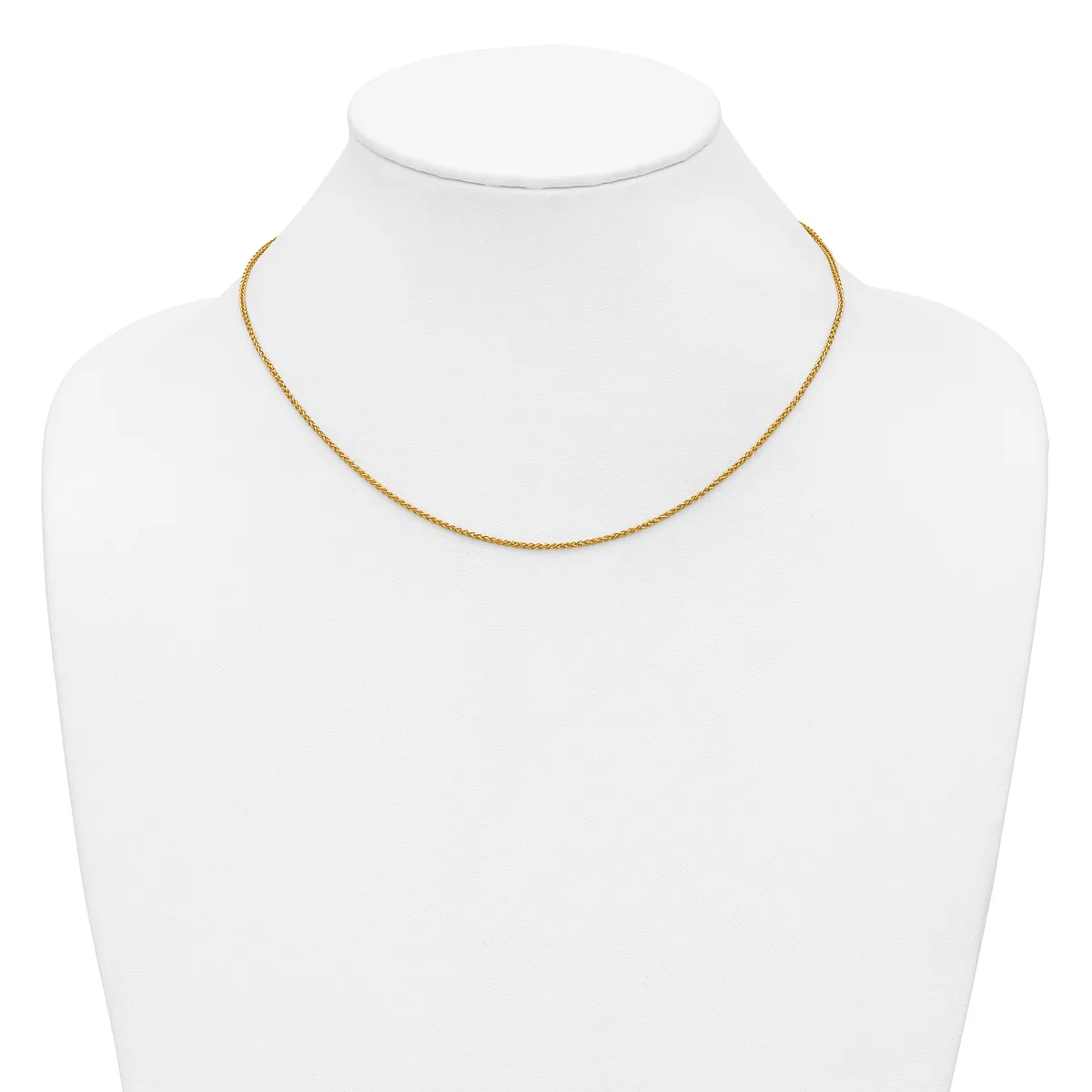 A delicate gold-toned chain necklace displayed on a white mannequin bust.