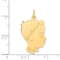 Gold-colored profile pendant of a woman's head with decorative line details, shown next to a measurement scale indicating approximately one inch in height.