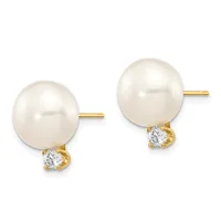 A pair of stud earrings featuring white pearls with gold posts and diamond accents beneath each pearl.