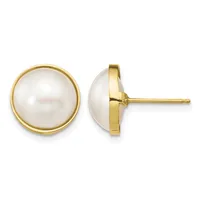 A pair of round white pearl stud earrings set in gold bezels, shown from front and side views.