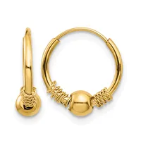 A pair of gold hoop earrings with textured wrap details and spherical charms, shown from front and side views.