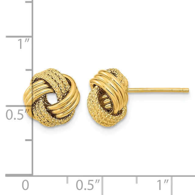A pair of gold twisted knot stud earrings with textured and polished surfaces, shown at actual size next to a measurement ruler.