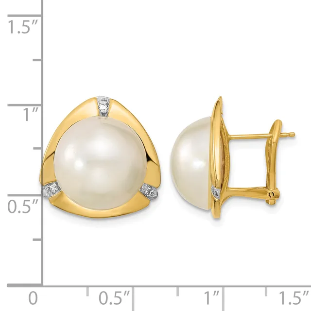 Pair of gold stud earrings featuring large cream pearls set in curved gold bezels with small diamond accents, shown at actual size on a measurement scale.