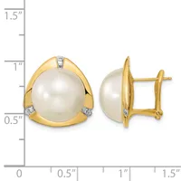 Pair of gold stud earrings featuring large cream pearls set in curved gold bezels with small diamond accents, shown at actual size on a measurement scale.
