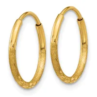 A pair of gold hoop earrings with a textured lower half and polished upper half, displayed against a white background.
