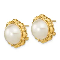 A pair of gold-toned stud earrings with oval white pearl centers surrounded by ornate textured gold settings.