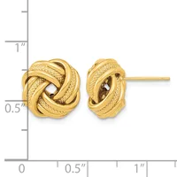 A pair of gold knot stud earrings with textured surfaces shown next to a ruler indicating approximately half an inch in height.