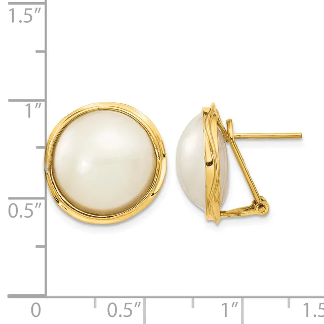 Pair of round white pearl stud earrings with gold-tone settings and omega backs, displayed next to a measurement ruler.