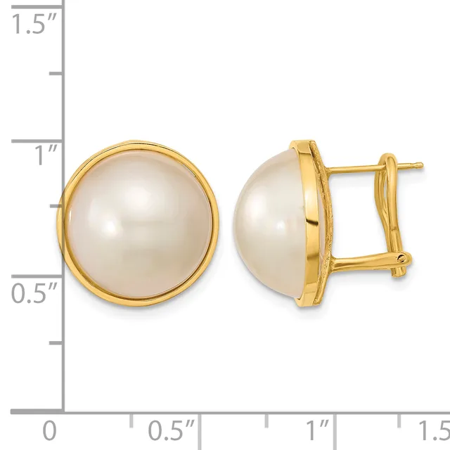 Pair of gold-toned stud earrings with large round white pearl centers in bezel settings, shown front and side view against a measurement scale.
