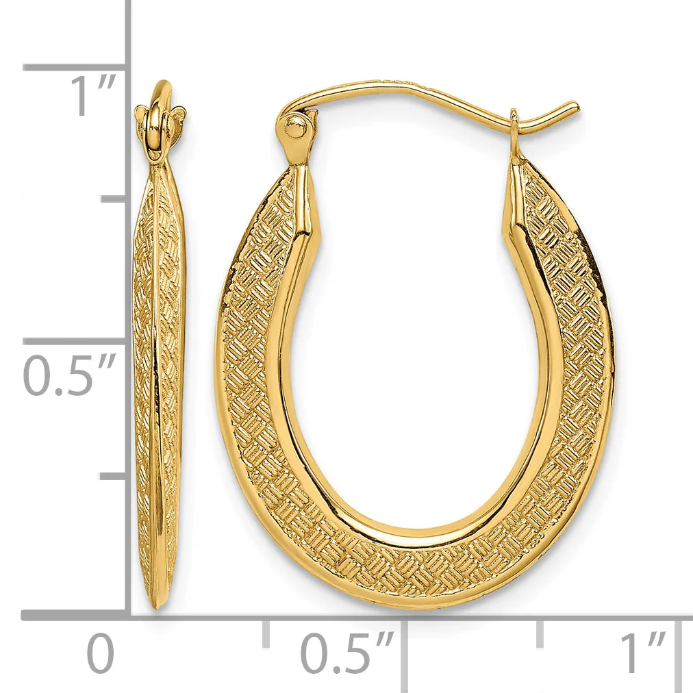 Gold oval hoop earrings with textured crosshatch pattern on the surface, shown with measurement scale indicating approximately one inch in length.