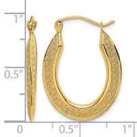 Gold oval hoop earrings with textured crosshatch pattern on the surface, shown with measurement scale indicating approximately one inch in length.
