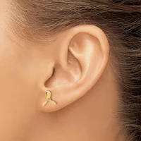 A gold stud earring with a curved three-pronged design worn in the lower lobe of a person's ear.