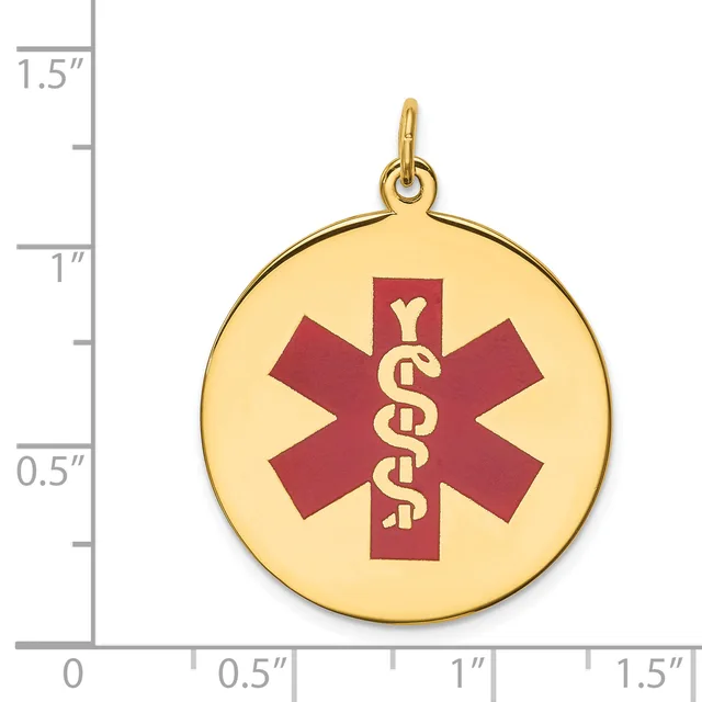 Gold-colored round medical alert pendant with a red star of life symbol and serpent staff, shown next to a ruler indicating approximately one inch in diameter.