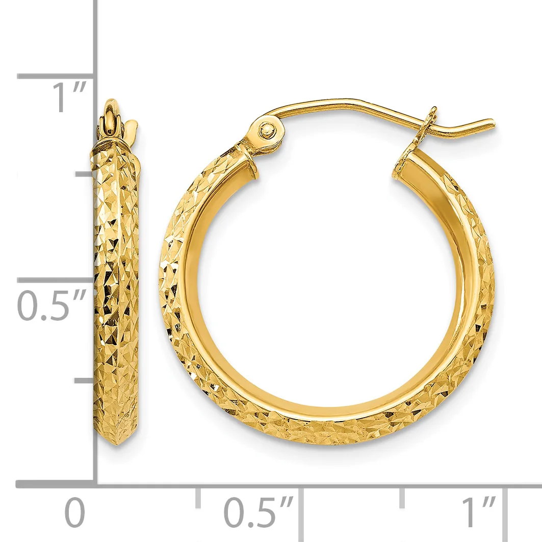 Gold textured hoop earrings with a hammered surface finish, shown next to a ruler displaying their size of approximately one inch in diameter.