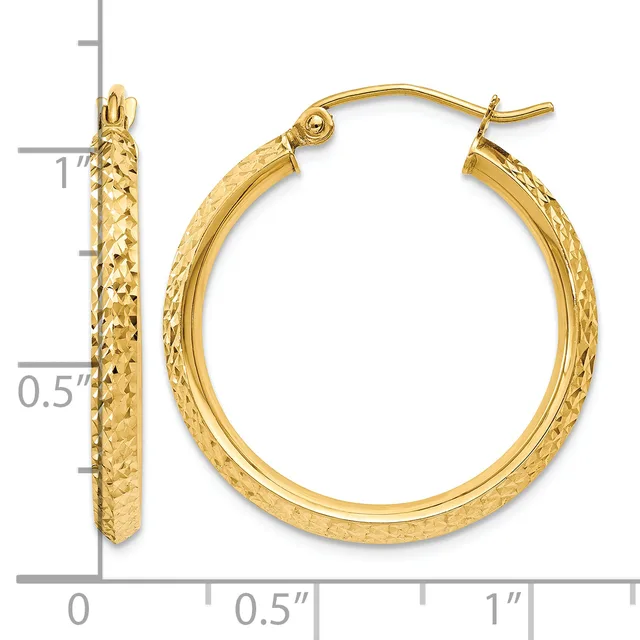 Gold hoop earrings with a textured diamond-cut surface, measuring approximately one inch in diameter, displayed next to a measurement scale.