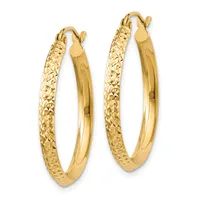 A pair of gold hoop earrings with textured outer surfaces and polished inner surfaces, displayed side by side against a white background.