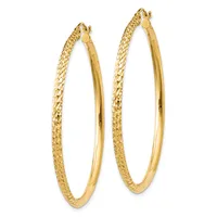 A pair of gold hoop earrings with textured outer surfaces and polished inner surfaces, displayed side by side against a white background.