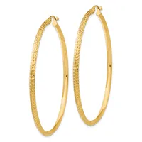 A pair of gold hoop earrings with textured outer surfaces and smooth inner surfaces, displayed against a white background.