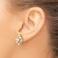 A gold-toned earring with multiple white pearl and crystal stones arranged in a clustered oval design, shown on a model's earlobe.