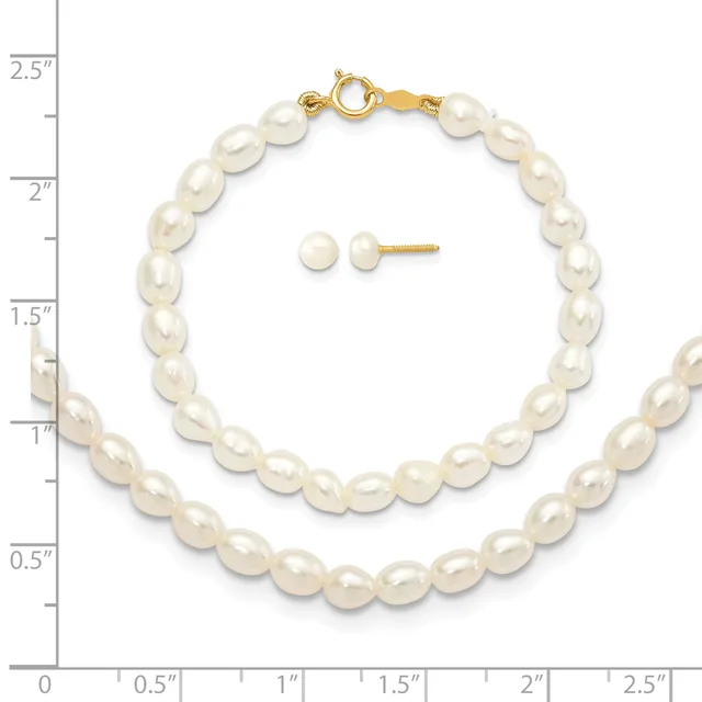 A white pearl bracelet with a gold clasp and matching white pearl stud earrings displayed next to a ruler showing scale.