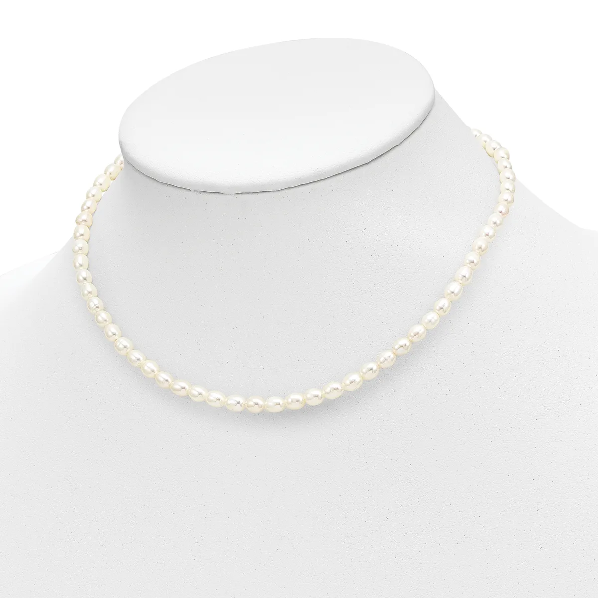 A strand of cream-colored round pearls displayed on a white mannequin bust, forming a classic single-strand necklace.