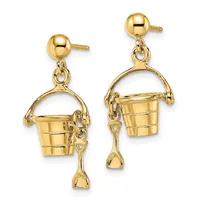 Pair of gold dangle earrings featuring bucket and spade charms suspended from ball studs.