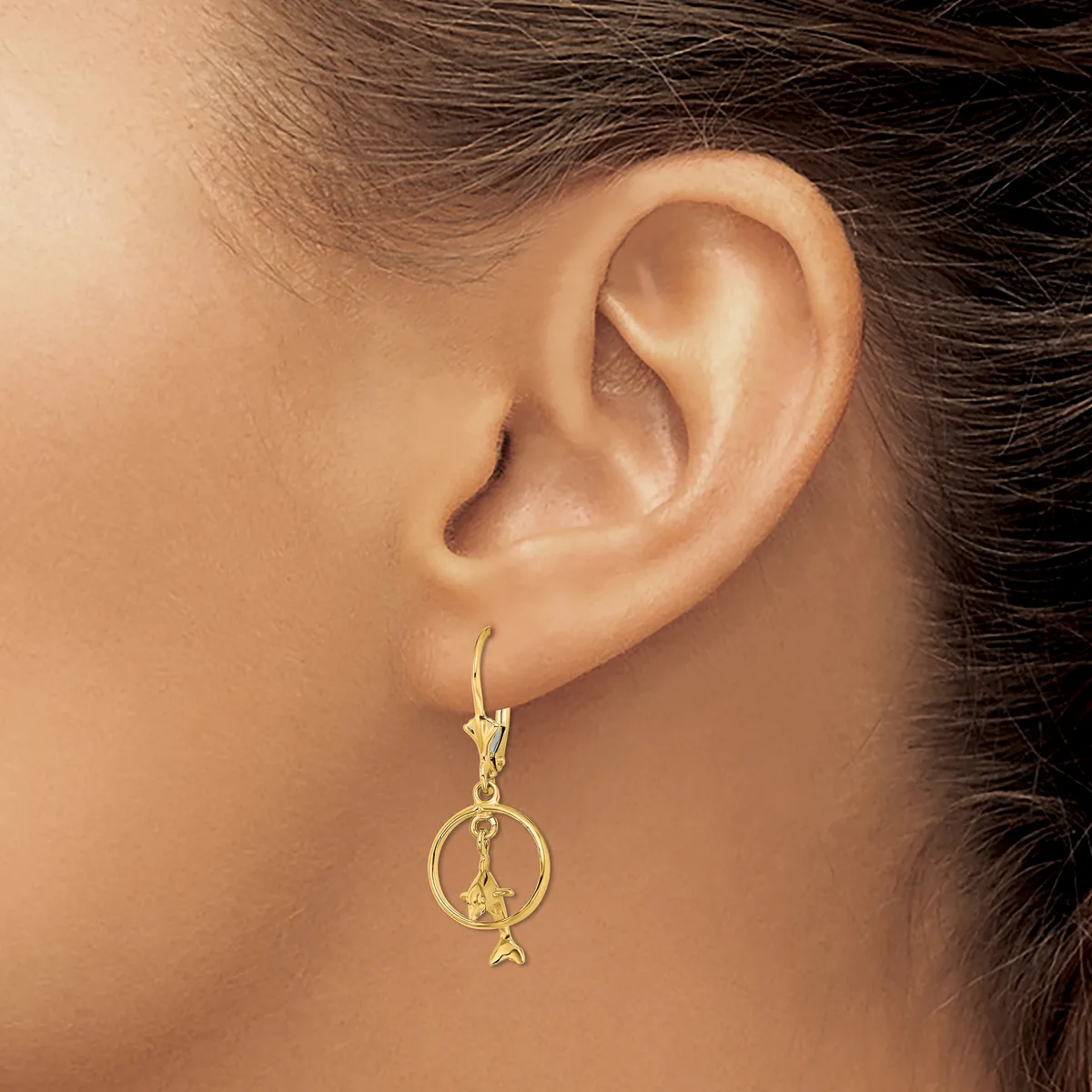 A person wearing a gold-toned dangle earring with a circular hoop and star charm, shown from the side view of their ear and neck.