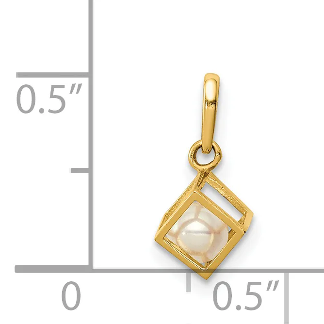 A gold-toned square pendant with a white pearl center, suspended from a matching bail, shown against a ruler indicating approximately half-inch dimensions.