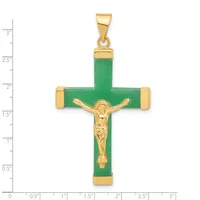 A green jade cross pendant with gold-tone metal accents and a gold crucifix figure in the center, shown against a ruler for scale.