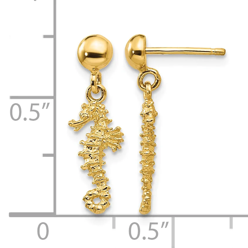 Pair of gold-colored seahorse dangle earrings with polished ball studs, displayed against a measurement scale showing approximately half-inch length.