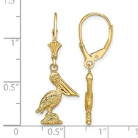 A pair of gold lever-back earrings with pelican charms hanging from decorative wire posts, displayed next to a measurement scale.