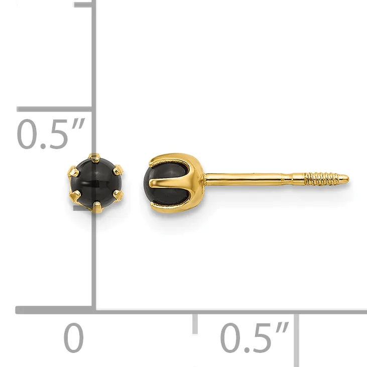 A pair of gold stud earrings with round black onyx stones set in prong settings, shown next to a measurement ruler indicating approximately 0.5 inches in length.