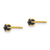 A pair of gold stud earrings with round black onyx stones set in decorative gold bezels with textured posts.