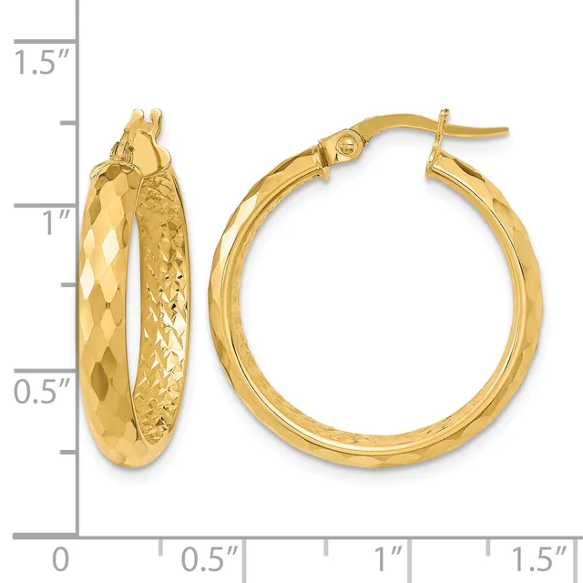 A pair of gold hoop earrings with textured and polished surfaces, shown next to a measurement scale indicating approximately one inch in diameter.