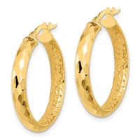 A pair of gold hoop earrings with faceted and textured surfaces, shown from the front against a white background.