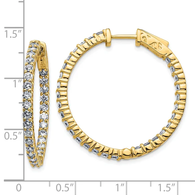 Gold hoop earrings with diamond accents and a ridged texture, shown next to a measurement ruler indicating approximately one inch in diameter.