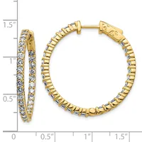 Gold hoop earrings with diamond accents and a ridged texture, shown next to a measurement ruler indicating approximately one inch in diameter.