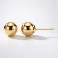 A pair of polished gold ball stud earrings with posts and backs, displayed against a white background.