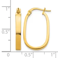 A pair of polished gold hoop earrings with a rectangular cross-section, displayed against a measurement scale showing approximately one inch in length.
