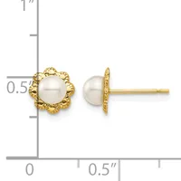 Pair of gold stud earrings featuring white pearl centers surrounded by textured gold flower-shaped settings, shown next to a ruler for scale.
